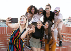 Friend group taking a picture using Nöz reef safe zinc oxide sunscreen, best spf for face, & recommended by dermatologists.